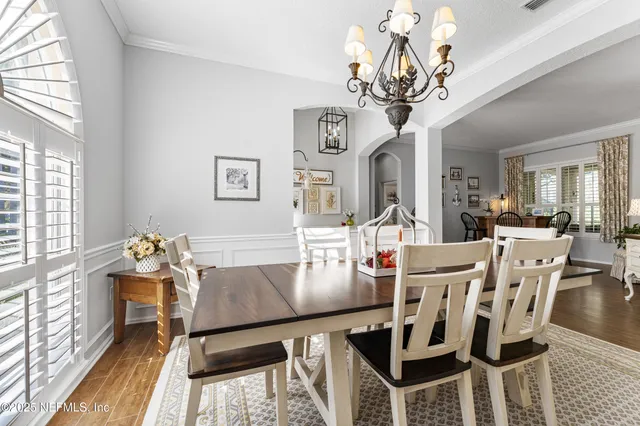 a view of a dining room with furniture and a chandelier