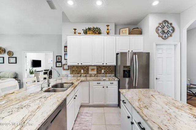 a kitchen with stainless steel appliances granite countertop a refrigerator sink and cabinets