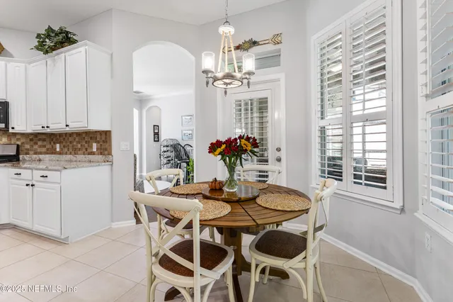 a view of a dining room with furniture and chandelier