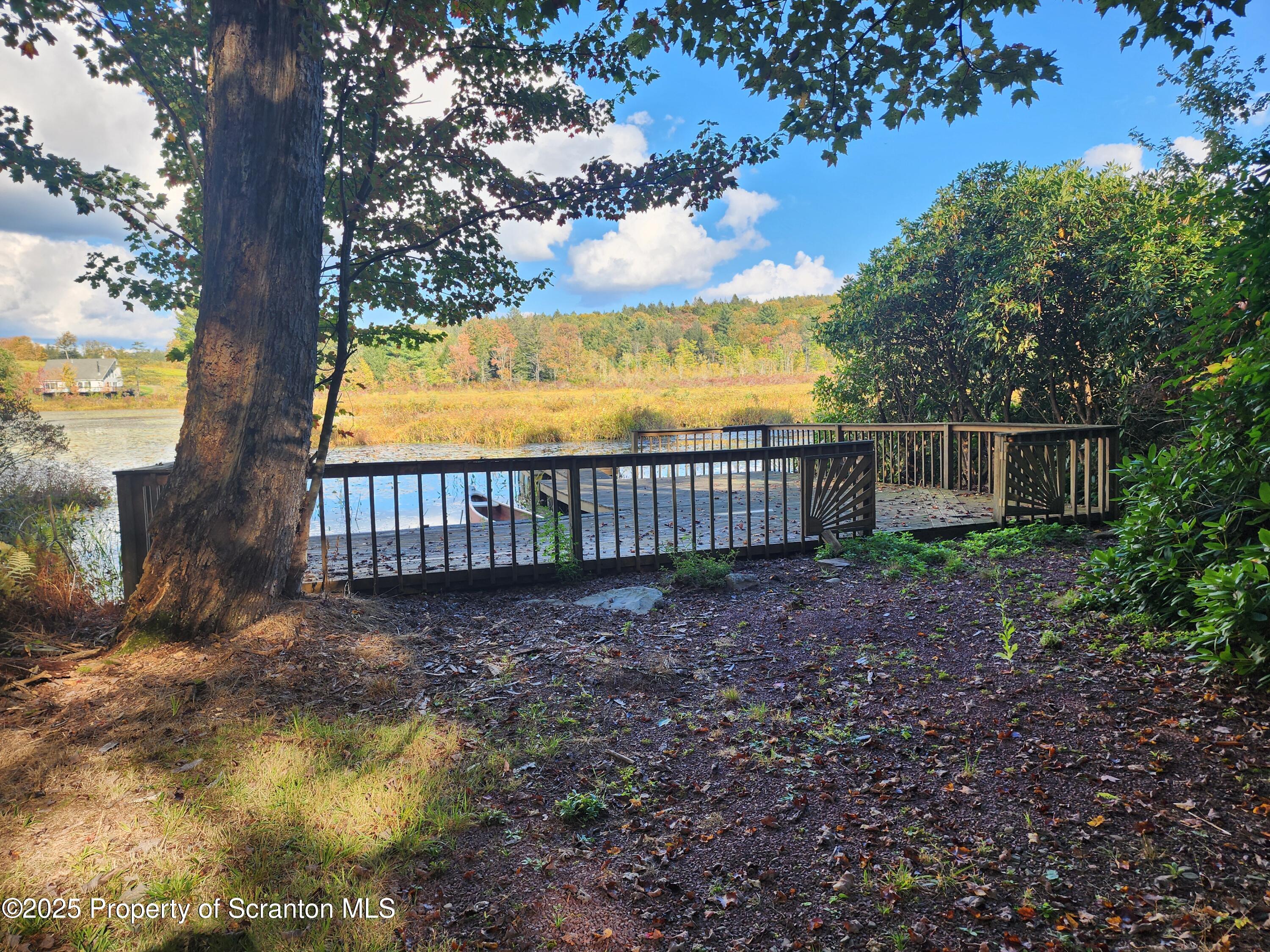 1526 Lakeview Road Susquehanna, PA 18847 - Photo 24 of 31 a view of a yard with large tree and wooden fence