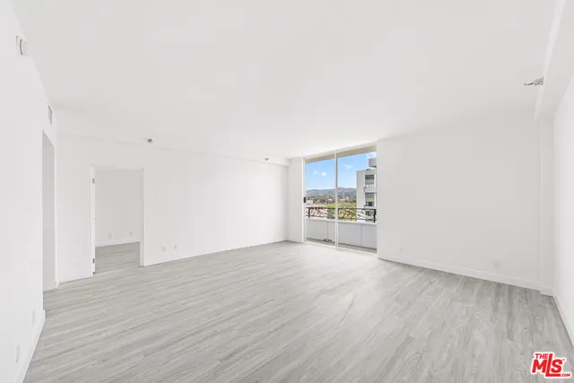 a view of a kitchen with wooden floor