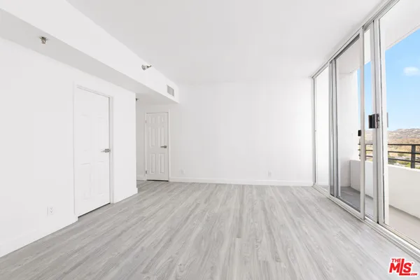 a view of hallway with wooden floor