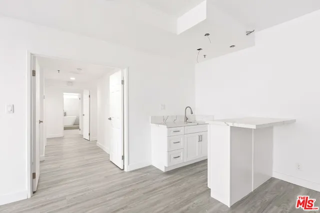 a view of a kitchen with wooden floor
