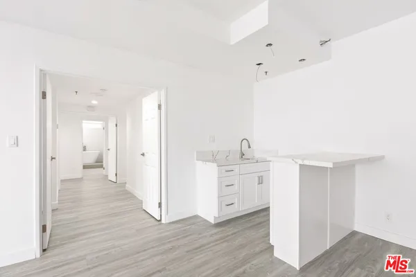 a view of a kitchen with wooden floor