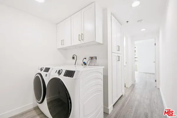 a view of washer and dryer with wooden floor