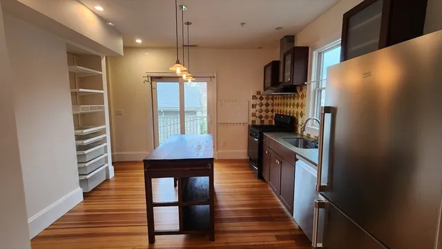 a kitchen with stainless steel appliances a refrigerator and a stove