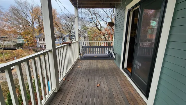 a view of a balcony with wooden floor