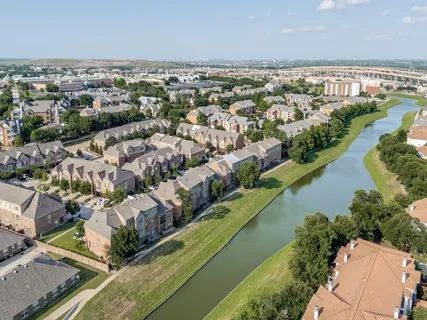 an aerial view of residential houses with outdoor space
