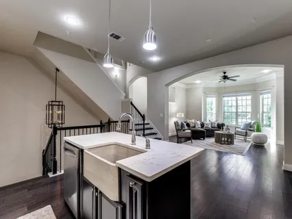 a kitchen with a table chairs and wooden floor