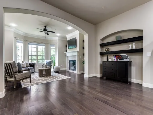 a living room with furniture and a wooden floor