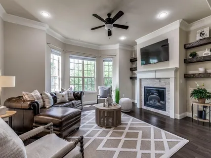 a living room with furniture fireplace and flat screen tv