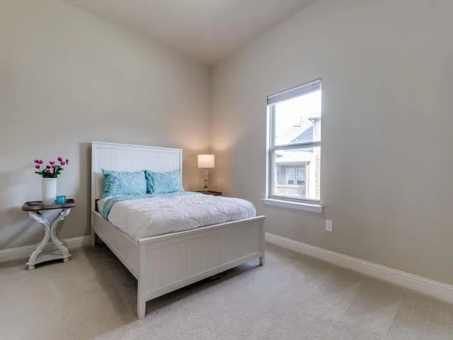 a bedroom with a bed and window