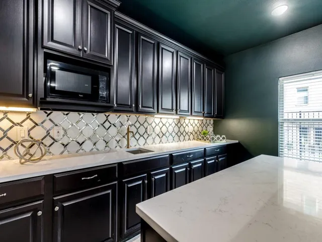 a kitchen with stainless steel appliances wooden cabinets and a stove top oven