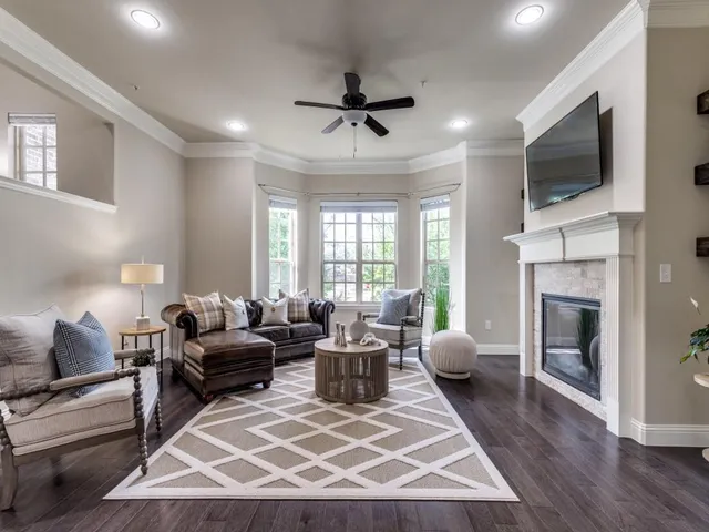 a living room with furniture a fireplace and a flat screen tv