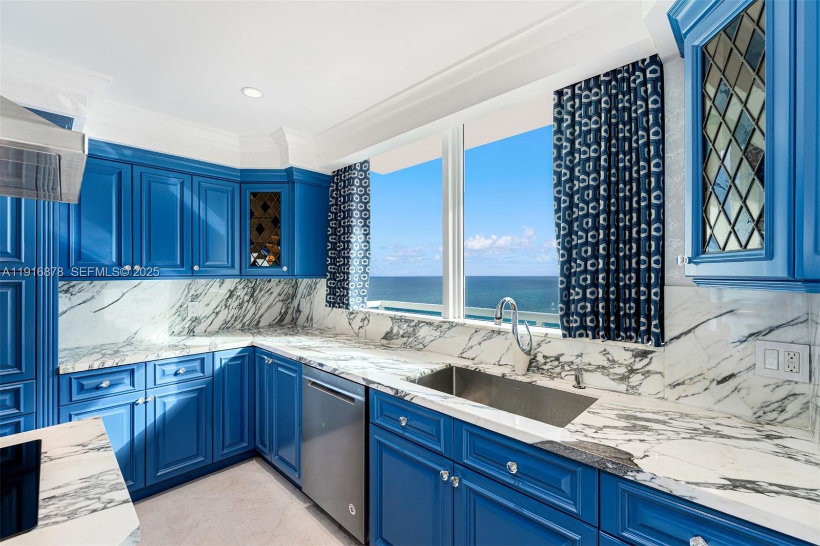 5025 Collins Avenue, Unit PH1 Miami Beach, FL 33140 - Photo 12 of 62 a kitchen with a sink and cabinets