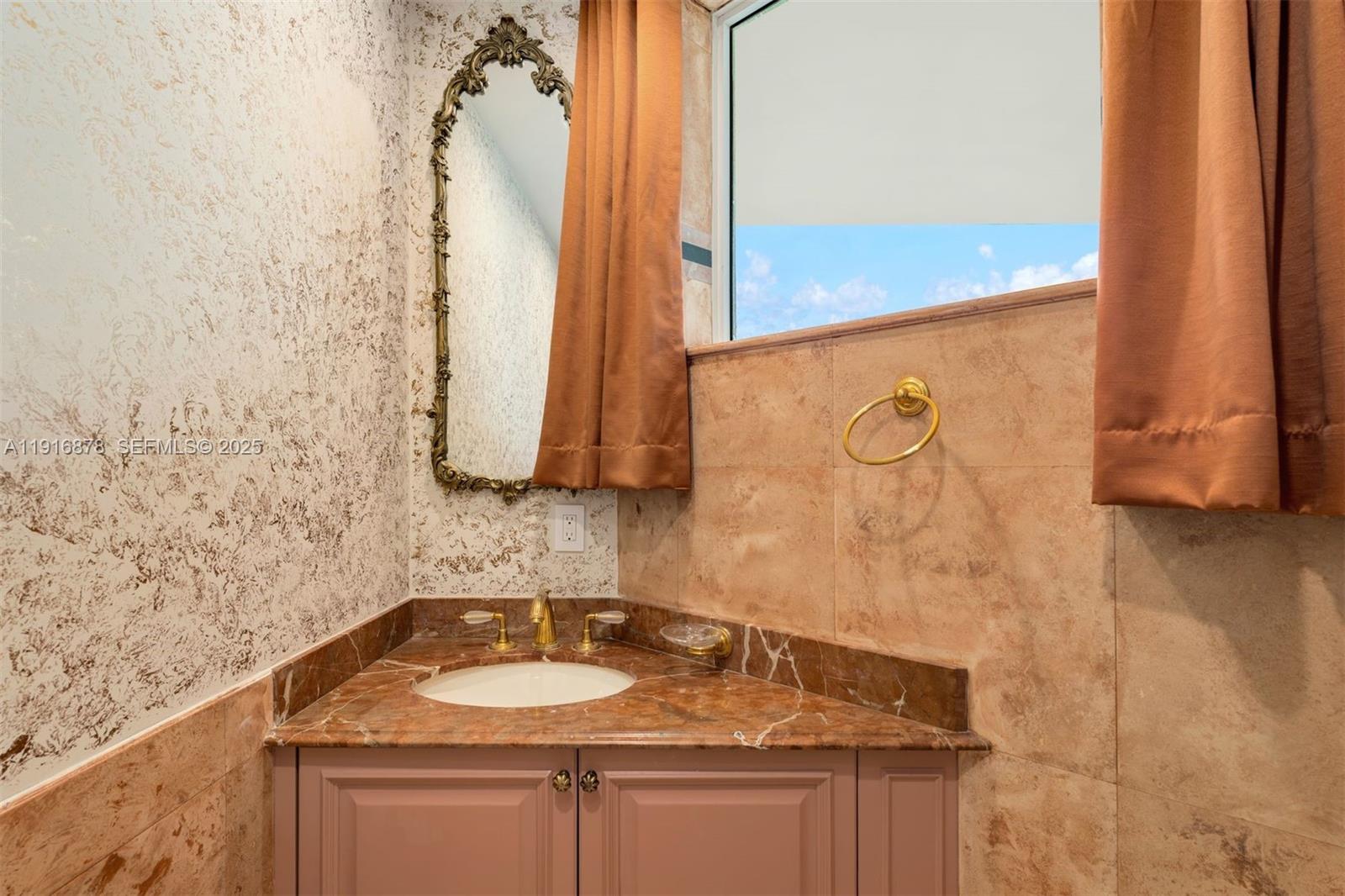 5025 Collins Avenue, Unit PH1 Miami Beach, FL 33140 - Photo 40 of 62 a bathroom with a granite countertop sink and a mirror