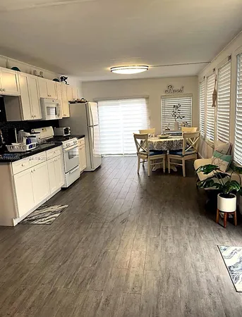 a kitchen with sink cabinets and wooden floor