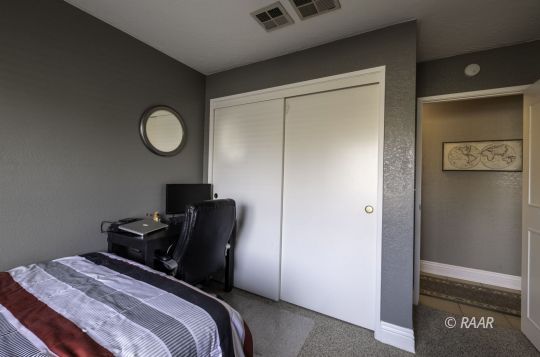 815 James Street Ridgecrest, CA 93555 - Photo 17 of 27 a bedroom with a bed and cabinets