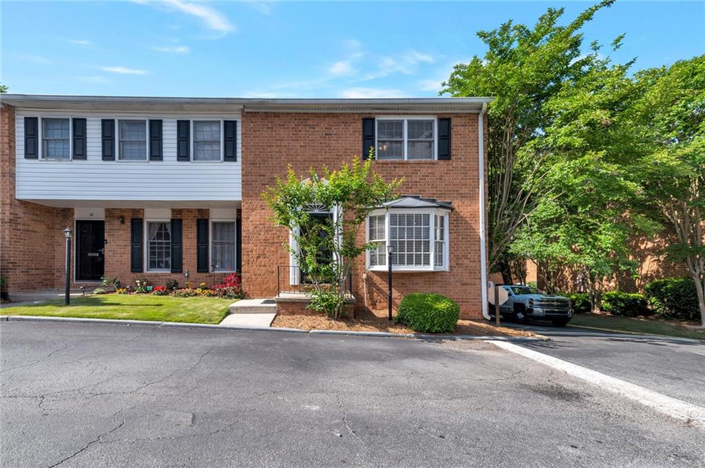 6520 Roswell Road Northeast, Unit 29 Atlanta, GA 30328 - Photo 1 of 1 a front view of a house with a yard