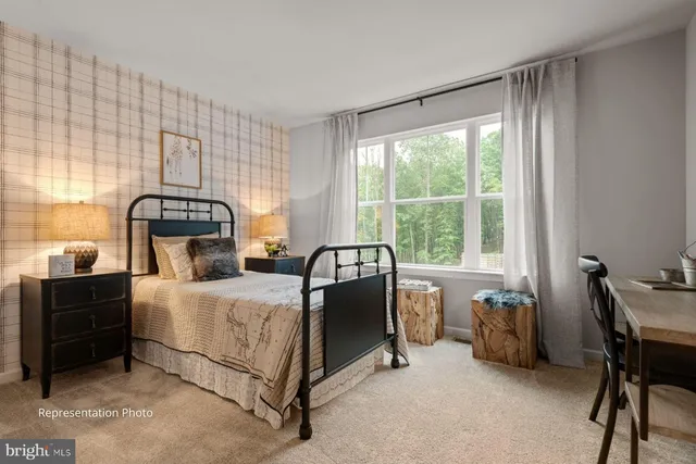 a bedroom with a bed chair and window