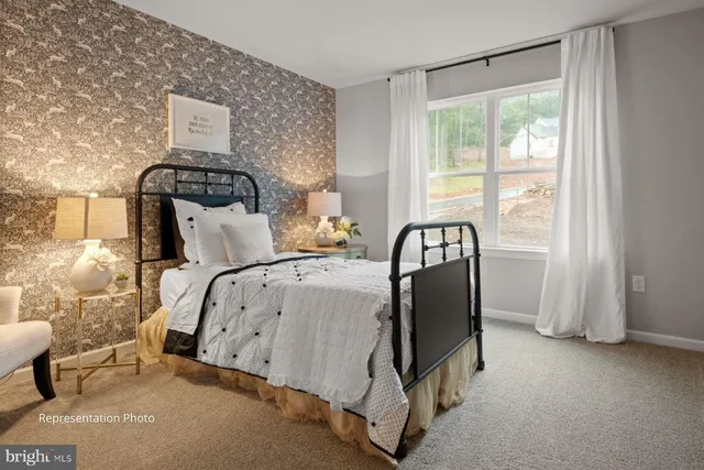 a bed sitting in a bedroom next to a window