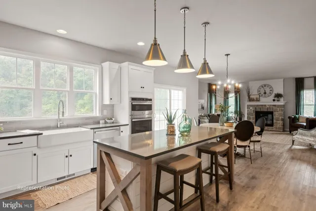 a dining room with furniture a chandelier and wooden floor