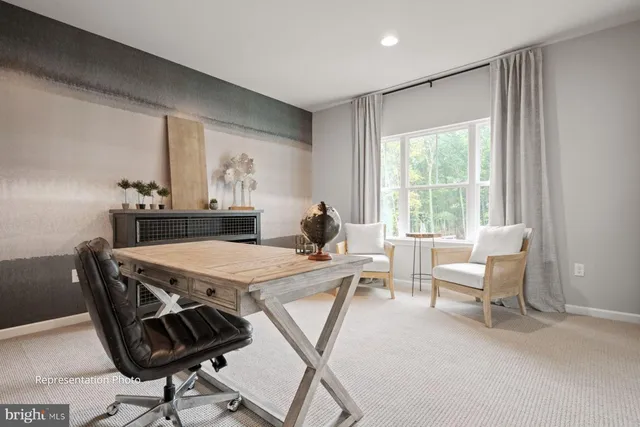 a living room with a table chairs and a window