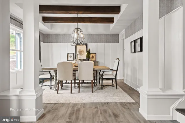 a view of dining room and livingroom with furniture wooden floor a chandelier