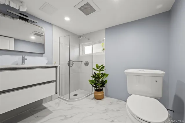 a bathroom with a toilet a sink and a window