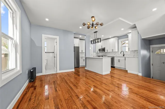 a view of a kitchen with a sink wooden floor and a window