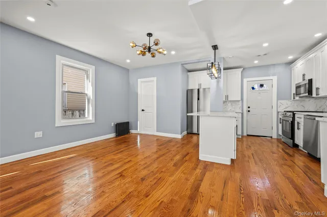a view of a kitchen with wooden floor and a kitchen