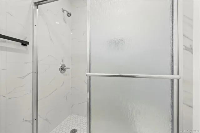 a bathroom with a glass shower door