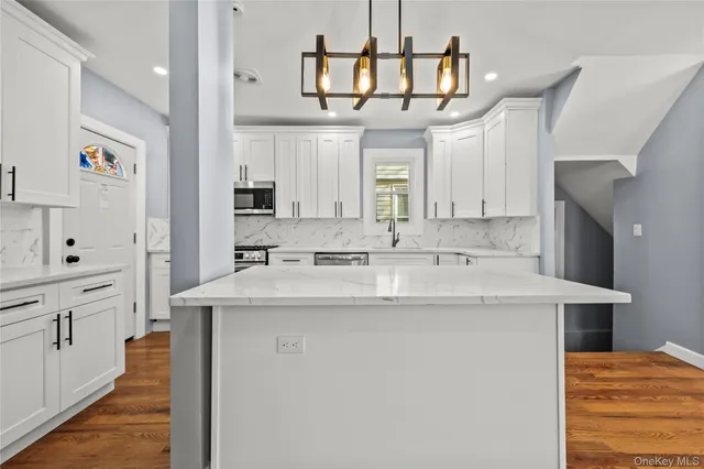 a kitchen with cabinets a sink and appliances
