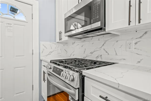 a stove top oven sitting inside of a kitchen