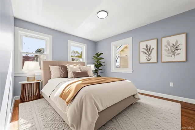 a bed room with a bed and a painting on the wall