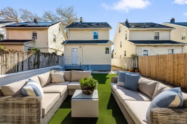 a view of a patio with couches and a fireplace