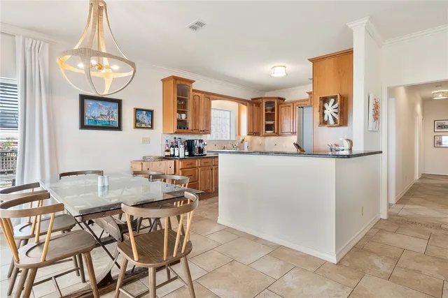a dining room with granite countertop a table and chairs