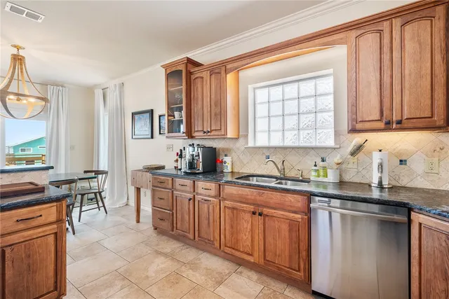 a kitchen with stainless steel appliances granite countertop a sink stove and cabinets