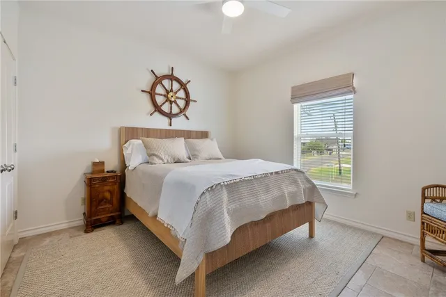a bed sitting in a bedroom next to a window