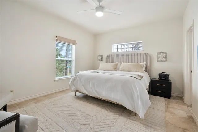 a bedroom with a bed and a window