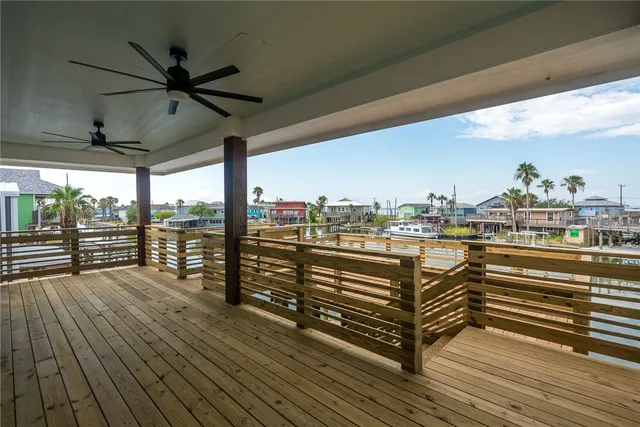a view of an empty room with a window and kitchen view