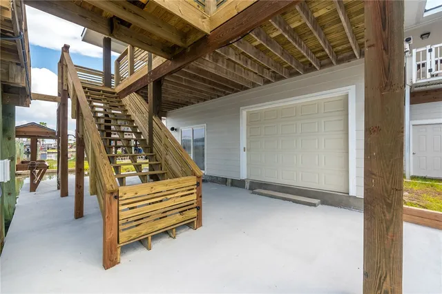 a bedroom with furniture and a large window