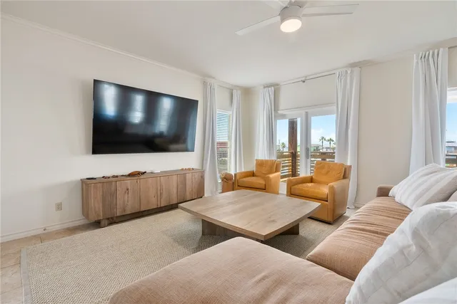 a living room with couches and a flat screen tv
