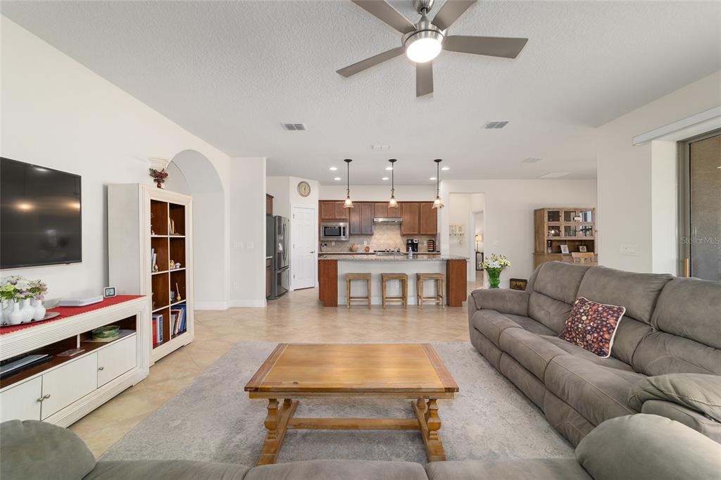 9603 Southwest 67th Street Ocala, FL 34481 - Photo 11 of 63 a living room with furniture and a flat screen tv
