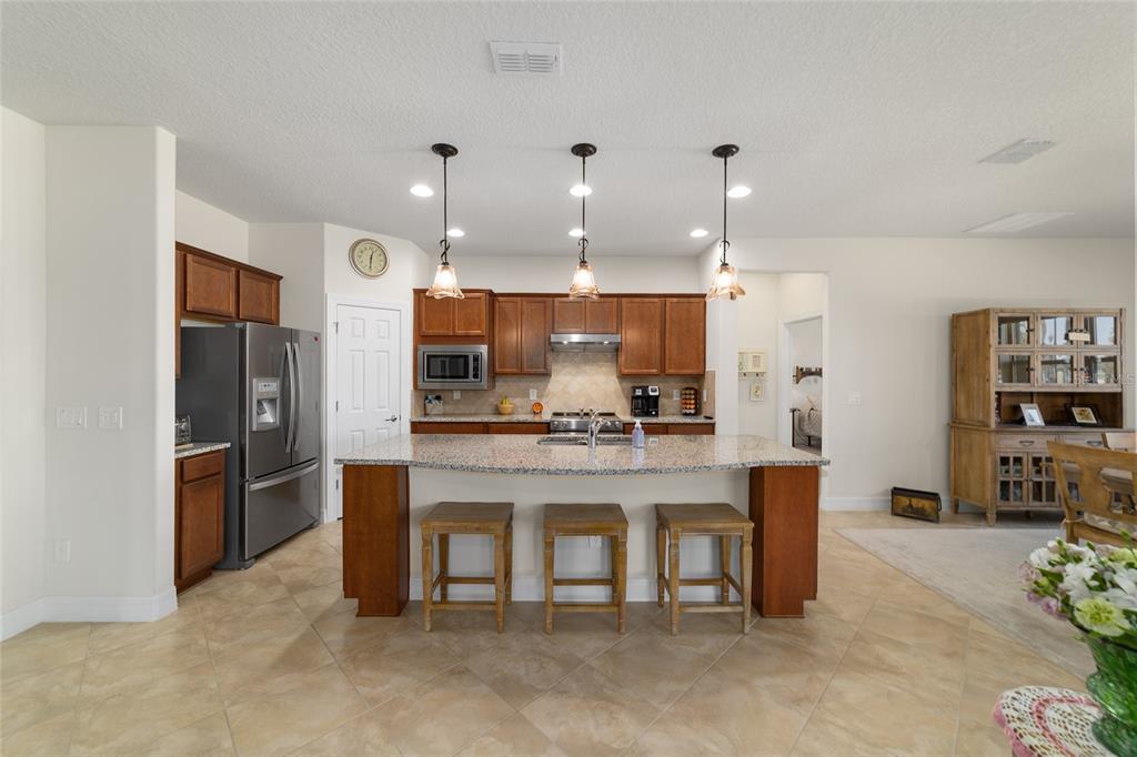 9603 Southwest 67th Street Ocala, FL 34481 - Photo 13 of 63 a large kitchen with a table and chairs