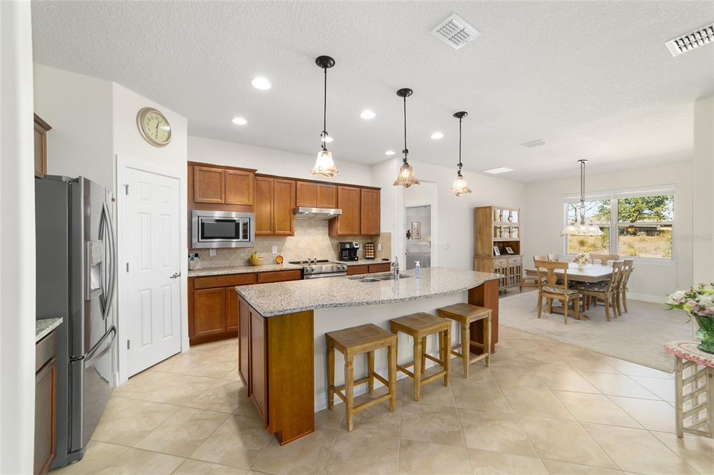 9603 Southwest 67th Street Ocala, FL 34481 - Photo 14 of 63 a large kitchen with a table and chairs