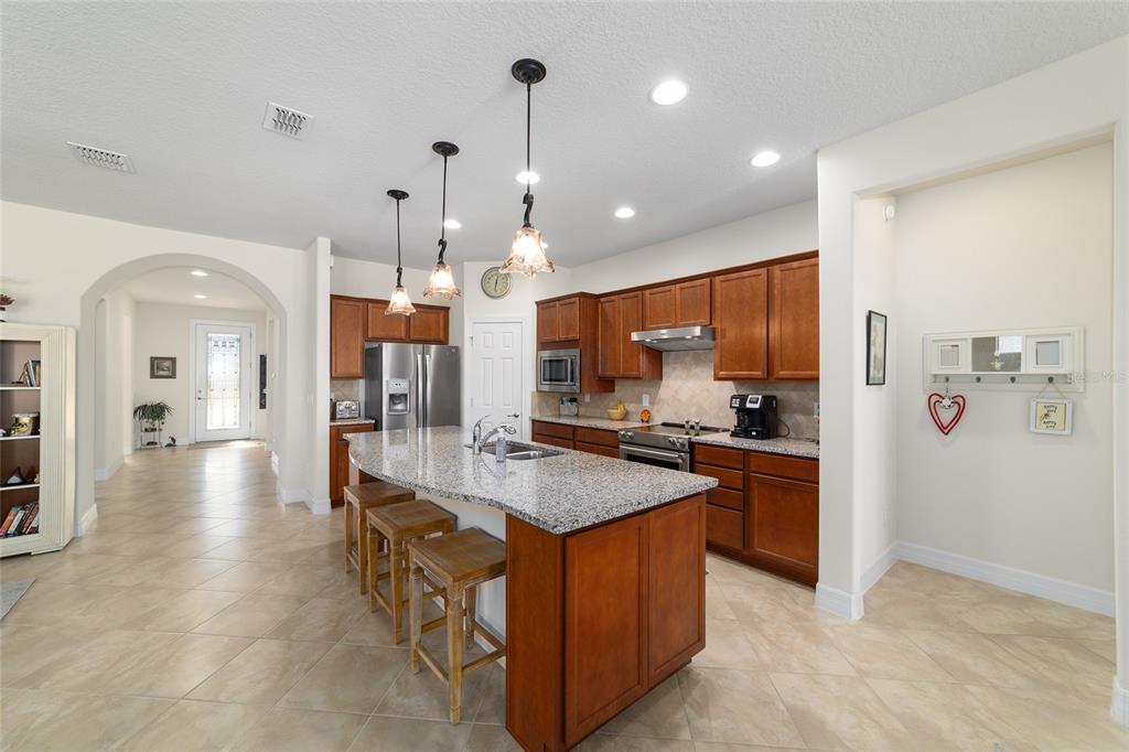 9603 Southwest 67th Street Ocala, FL 34481 - Photo 15 of 63 a large kitchen with stainless steel appliances kitchen island granite countertop a large counter top and sink