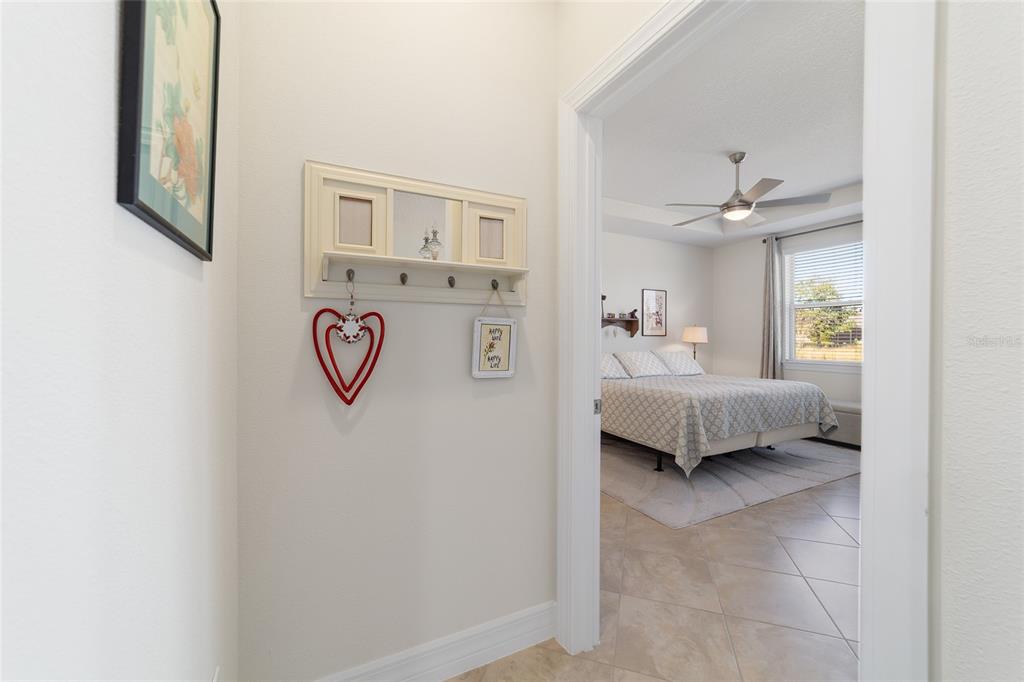 9603 Southwest 67th Street Ocala, FL 34481 - Photo 22 of 63 a bedroom with a bed and a chandelier