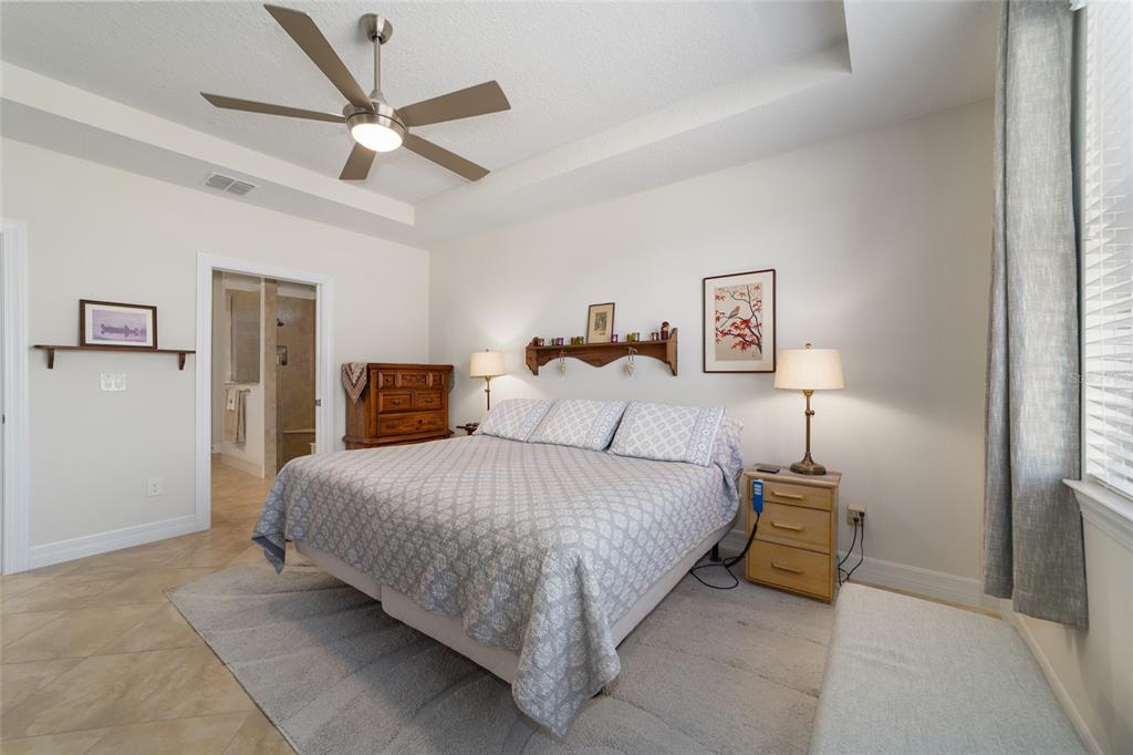 9603 Southwest 67th Street Ocala, FL 34481 - Photo 24 of 63 a spacious bedroom with a bed and a ceiling fan