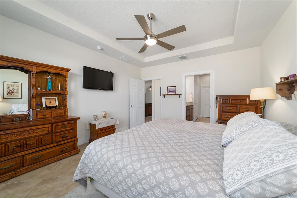 9603 Southwest 67th Street Ocala, FL 34481 - Photo 25 of 63 a bedroom with a bed and a flat screen tv